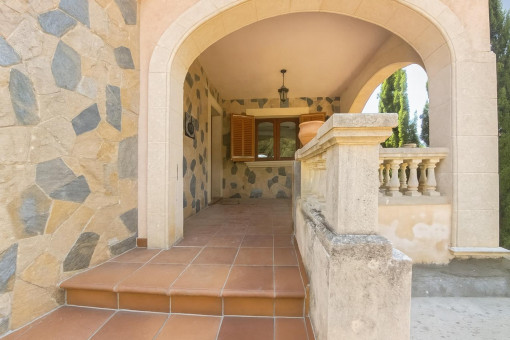 Stone patio with arch and balustrade