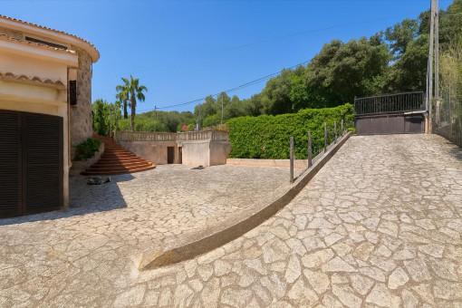 Stone driveway with gated parking