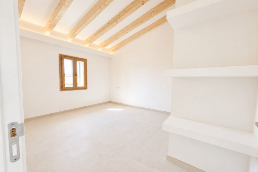 Bedroom with high ceilings and exposed wooden beams