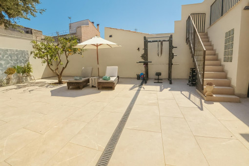 Spacious sunny patio with garden area