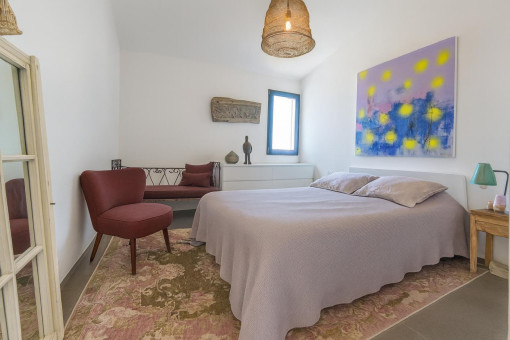 Bedroom with art and seating area