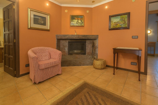 Cozy hallway with fireplace and armchair