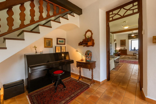 Inviting hallway with piano and stairs