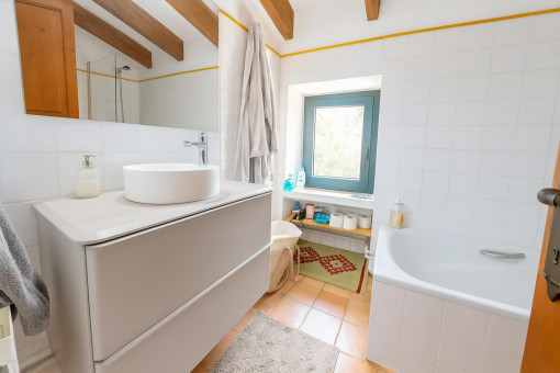 Bright small bathroom with bathtub