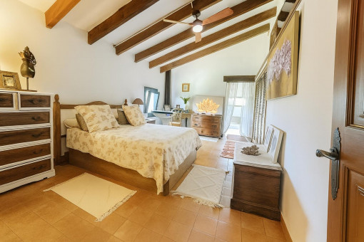 Bright bedroom with beamed ceiling