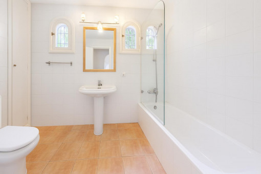 Bright bathroom with bathtub and shower