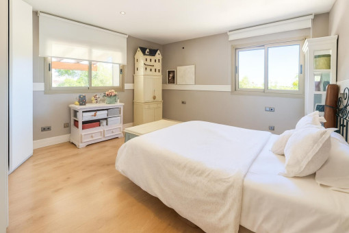 Bright bedroom with wooden floor