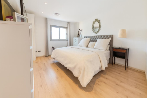 Bright second bedroom with wooden flooring