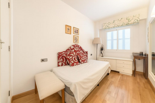 Small bedroom with window and wood floor