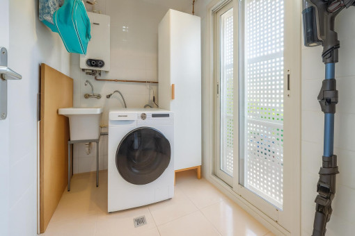 Clean laundry room with washing machine