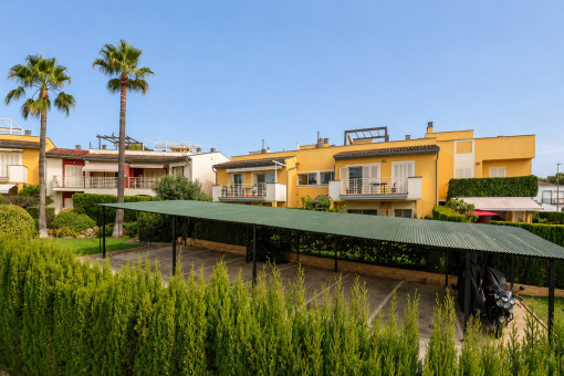 Covered outdoor parking spaces with garden view