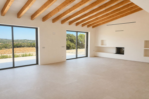Bright living area with exposed wooden beams and fireplace