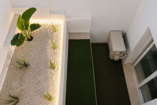 Planted lightwell with atmospheric lighting