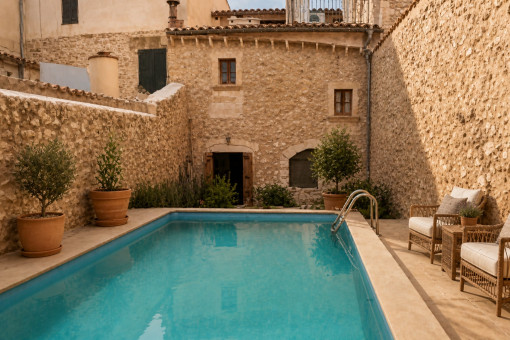 Private pool with stone walls and chairs