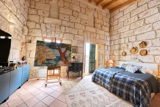 Bedroom with stone walls and natural light