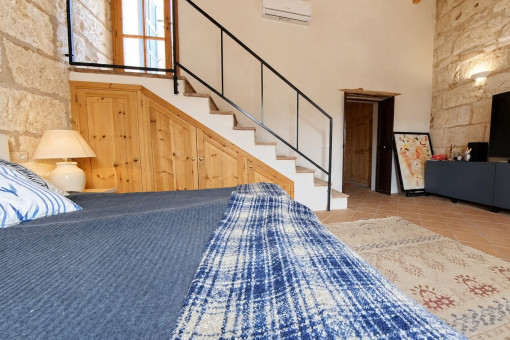 Cozy bedroom with stairs and TV