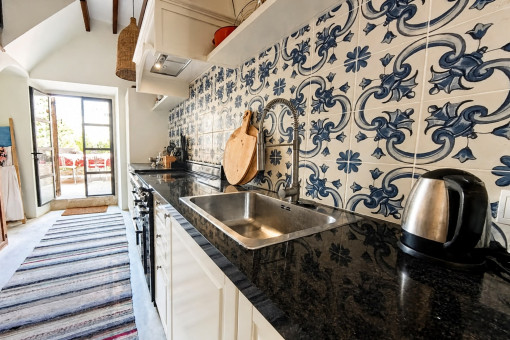 Narrow kitchen with decorative tiling
