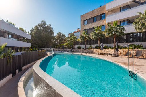 Large communal pool with sunbathing area