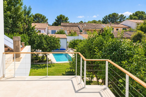 View of the garden and pool from the upper terrace