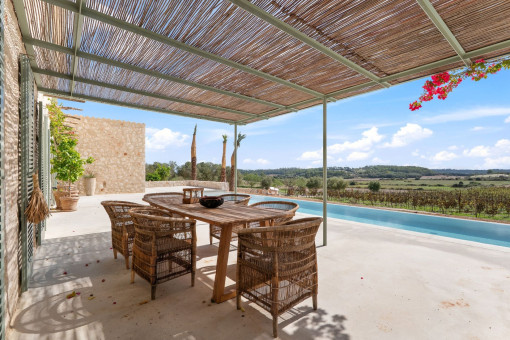 Covered outdoor dining area overlooking the pool