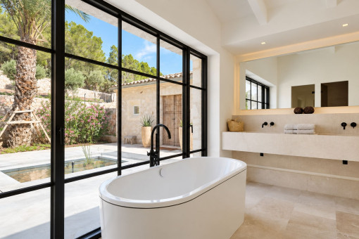 Freestanding bathtub with garden views